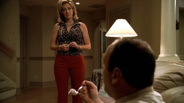 Carmela Soprano standing over a sitting Tony Soprano