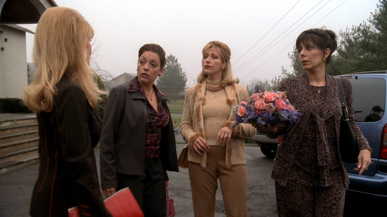 Carmela Soprano outside talking to three women