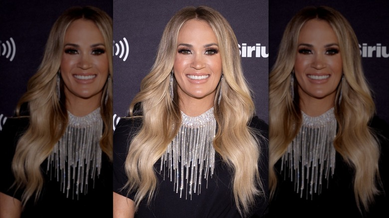 Carrie Underwood in a black shirt with diamond necklace