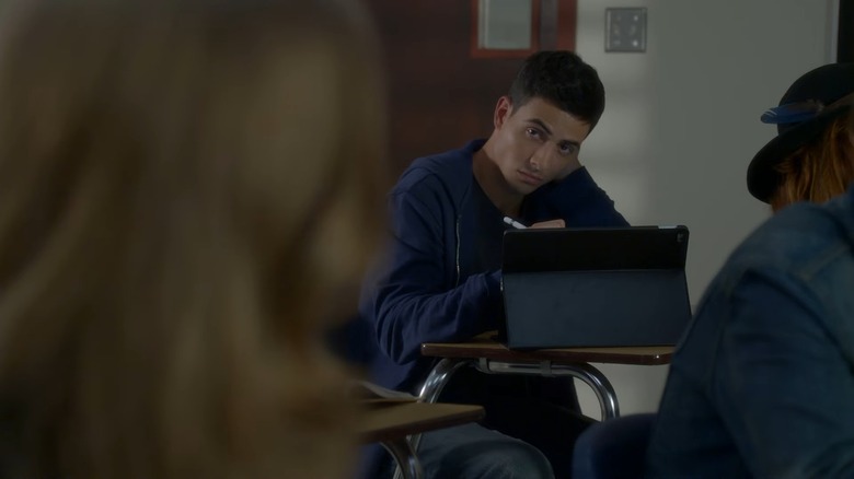 Santiago Segura behind an iPad staring at the camera, from Scream: The TV Series