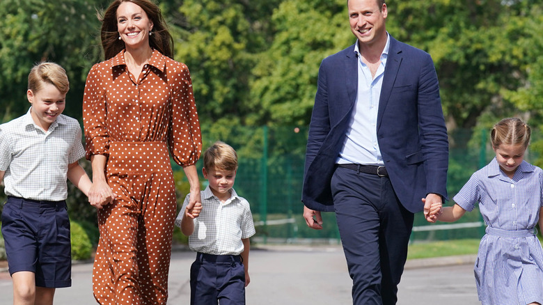 The Wales family holding hands