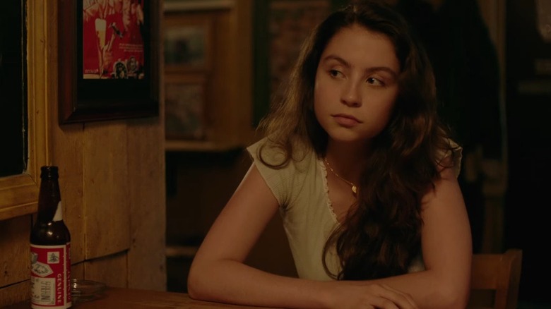 Carys Zeta Douglas sits at a table in a scene from "F**k That Guy."