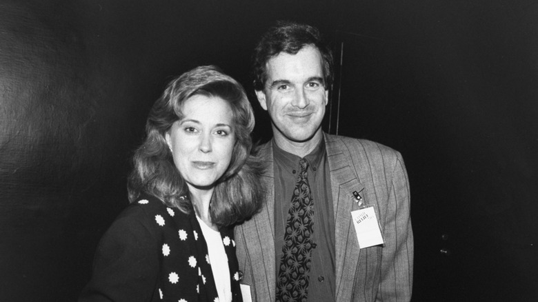 Black and white photo of Jane Pauley turning her head to look at the camera next to husband Garry Trudeau.