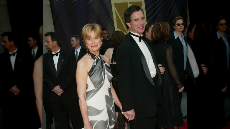 Jane Pauley and husband Garry Trudeau holding hands on a red carpet.