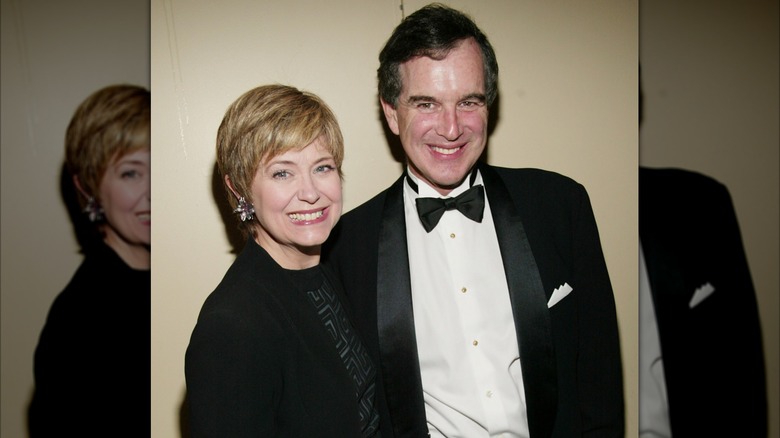 Jane Pauley wearing a black jacket and black and gray patterned shirt beside Garry Trudeau, who wears a tux.