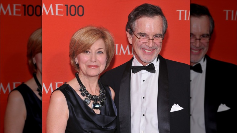 Jane Pauley and husband Garry Trudeau in front of the Time 100 background