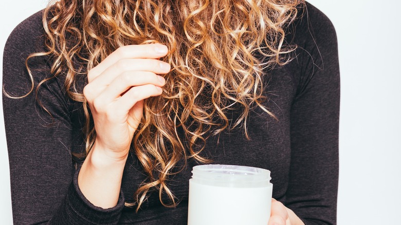 woman applying cream to hair