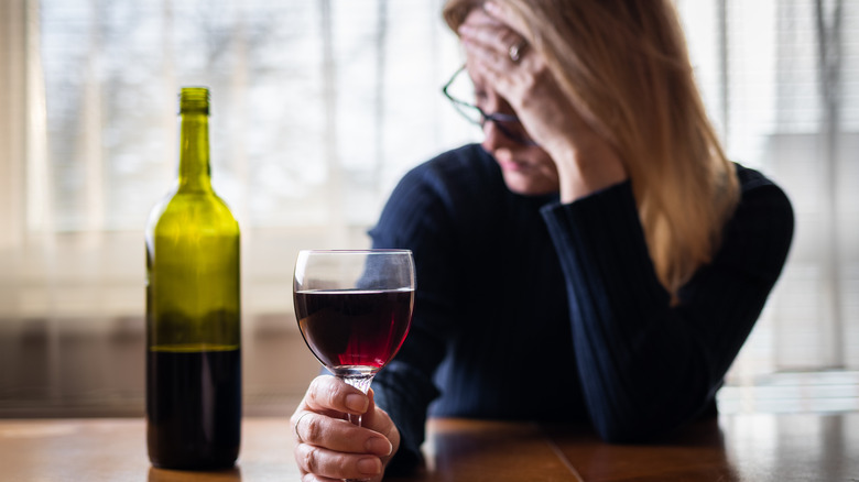 Stressed woman drinking alcohol