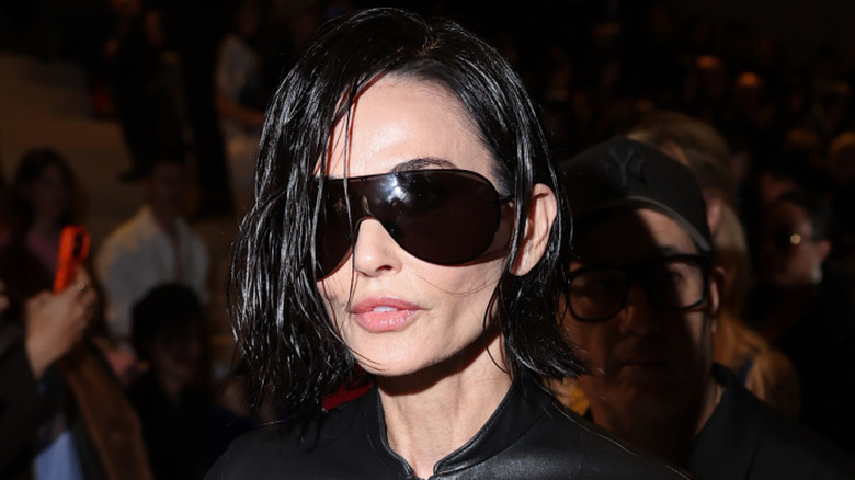 Demi Moore walking into the Gucci FW26 show with her dog