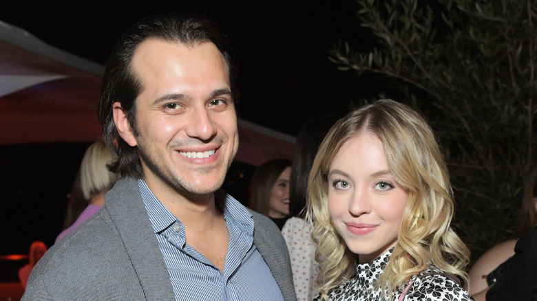 Jonathan Davino next to Sydney Sweeney, both smiling and looking at camera.