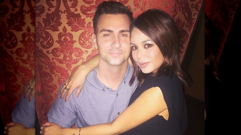 Chris Long looking serious and Janel Parrish smiling