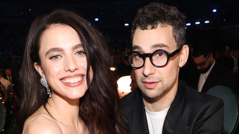 Margaret Qualley smiling and Jack Antonoff looking serious