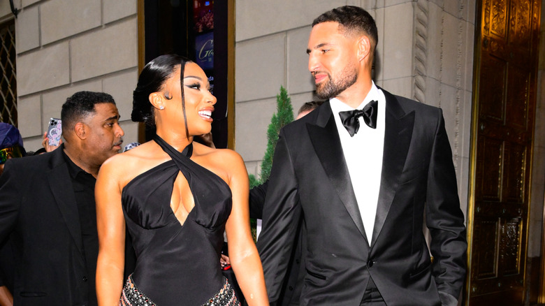 Megan Thee Stallion and Klay Thompson smiling at each other