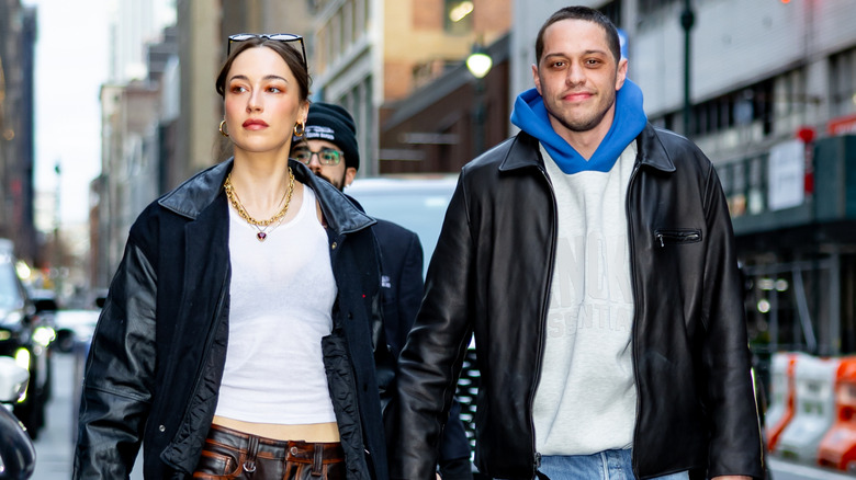 Elsie Hewitt and Pete Davidson walking while holding hands