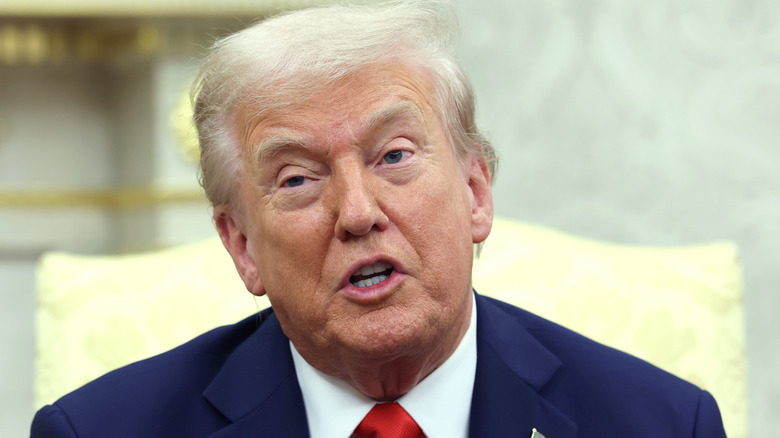 Donald Trump head tilted speaking in Oval Office