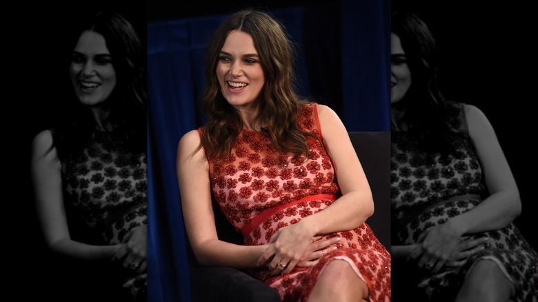Pregnant Keira Knightley wearing a red floral dress