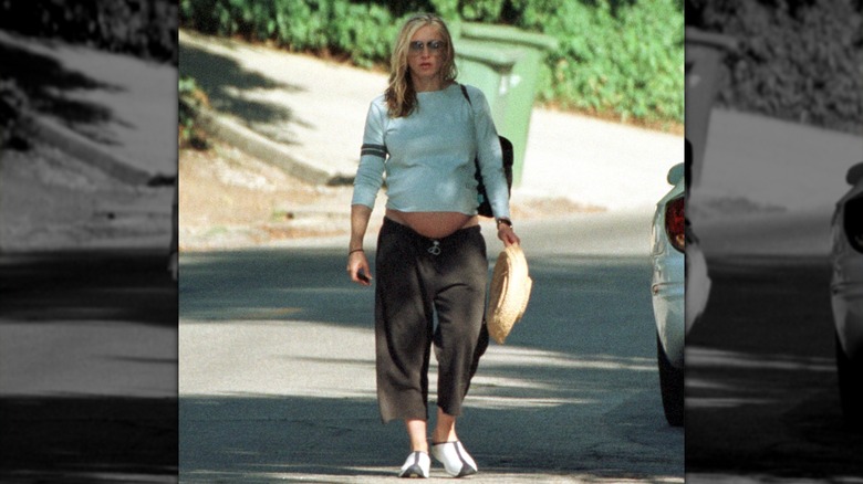 Madonna during her pregnancy in a blue T-shirt and cargos