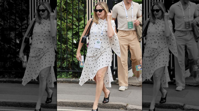 Pregnant Margot Robbie in a polka dotted dress at Wimbledon