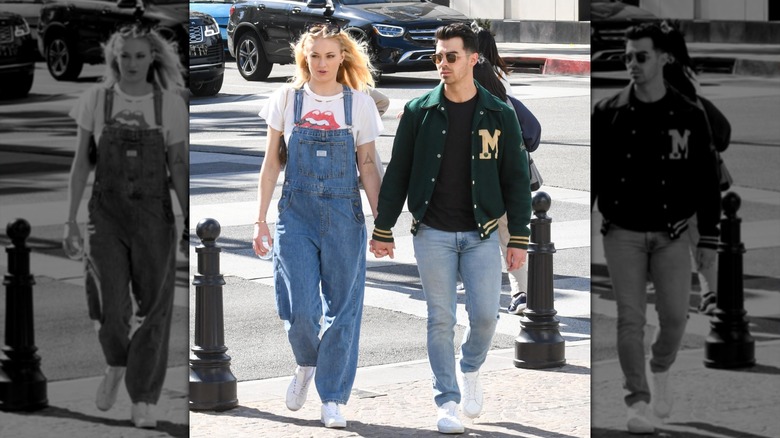 Sophie Turner in denim dungarees while pregnant beside Joe Jonas