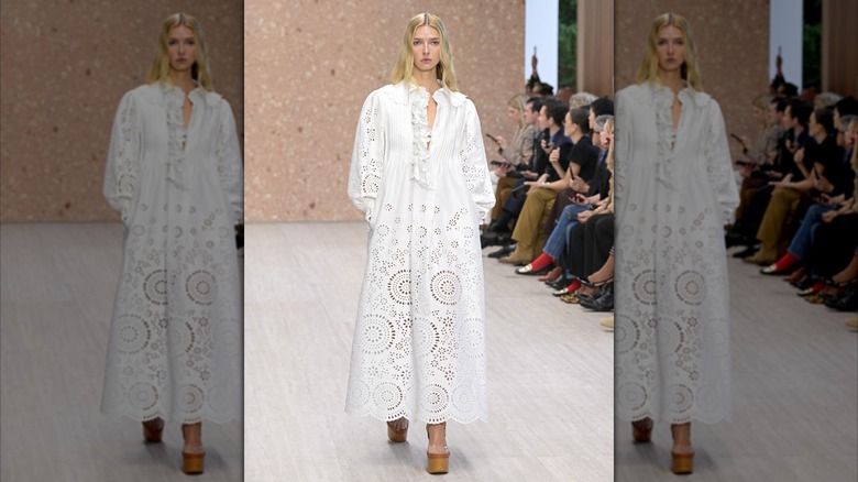 Apple Martin wearing all-white while runway modeling