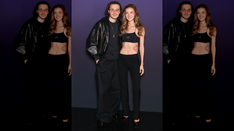 Brooklyn Beckham and Nicola Peltz smiling while wearing all-black