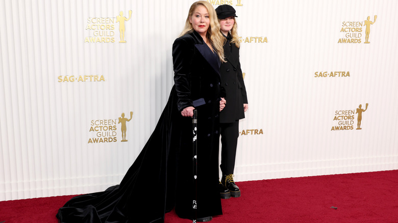 Christina Applegate holding walking stick on red carpet with her daughter