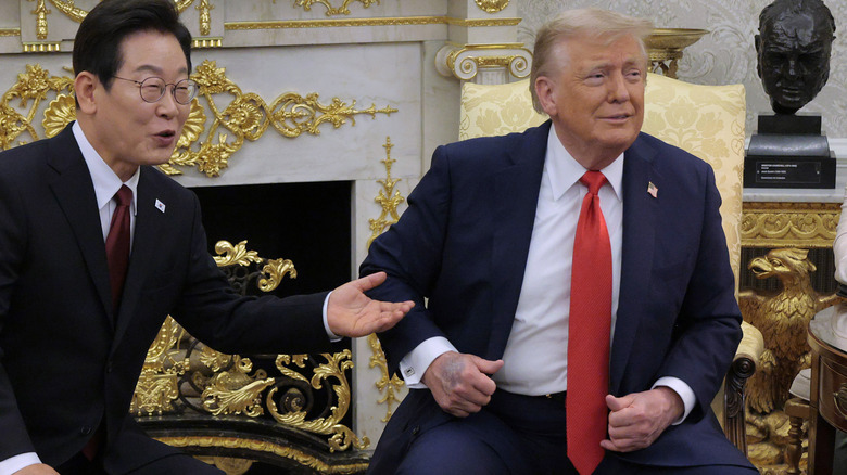 Lee Jae-myung and Donald Trump talk to reporters as Trump's bruised hand is on display