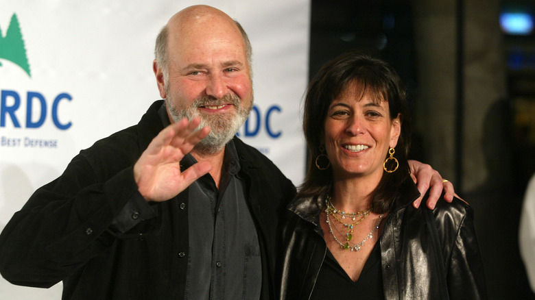 Rob Reiner waving while standing beside Michele Singer