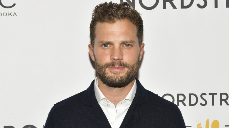 Jamie Dornan poses at an event