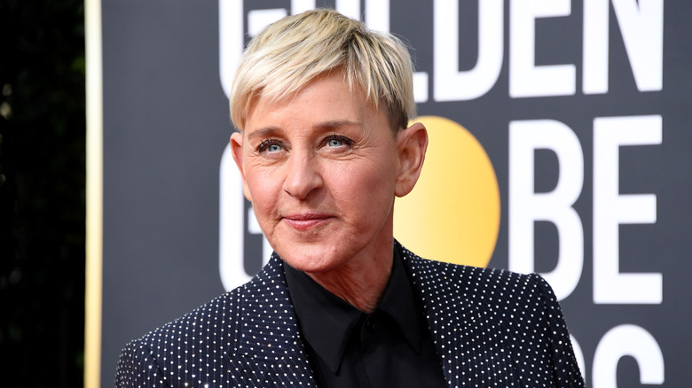 Ellen DeGeneres posing for photos in a polka dot blazer