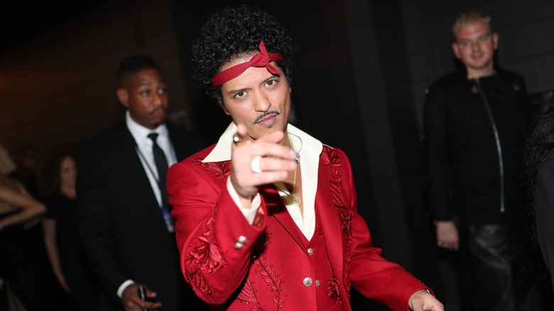 Bruno Mars pointing his finger at the camera at the 2026 Grammy Awards.