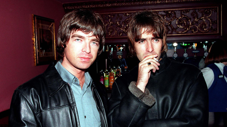 Liam Gallagher and Noel Gallagher posing for a photoshoot for Oasis