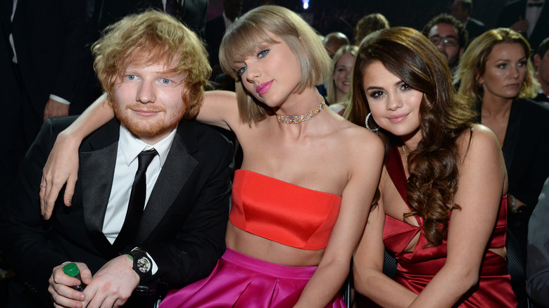 Ed Sheeran, Taylor Swift, and Selena Gomez sitting at the 2016 Grammys