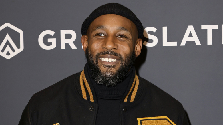 Stephen "tWitch" Boss smiling on step-and-repeat