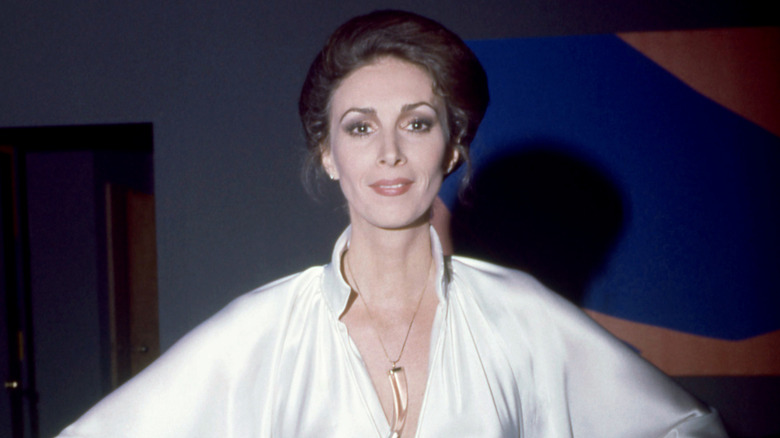 Wilhelmina Cooper smiling in a white satin outfit