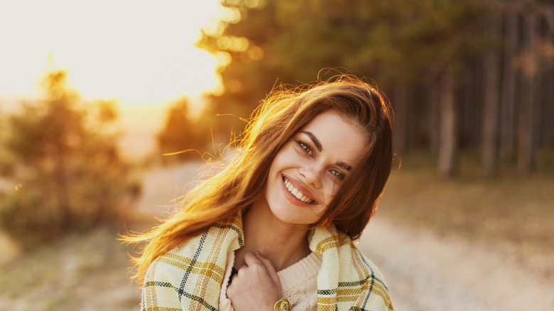 woman smiling in fall weather 