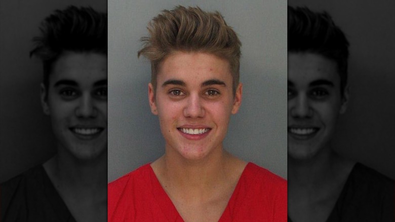 Justin Bieber smiling in his mugshot