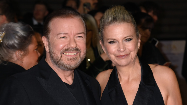 Ricky Gervais and Jane Fallon smiling in black formals