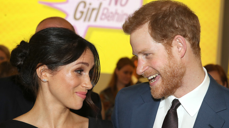 Prince Harry smiling at Meghan Markle