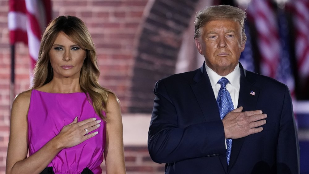 Donald and Melania Trump with their hands over their heart