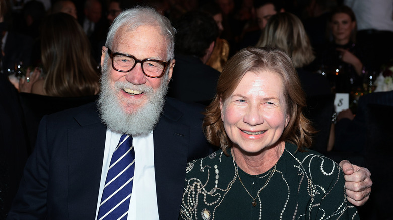David Letterman in blue suit and striped tie with Regina Lasko in patterned blouse