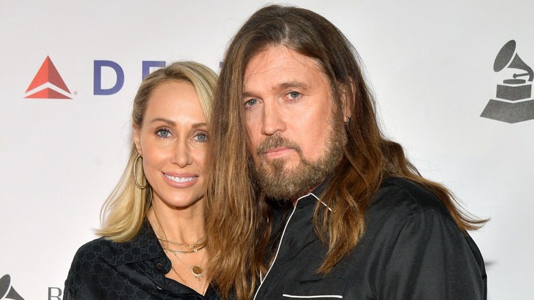 Billy Ray Cyrus and Tish Cyrus in black outfits