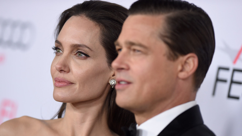 Closeup of Angelina Jolie with Brad Pitt blurred in the foreground