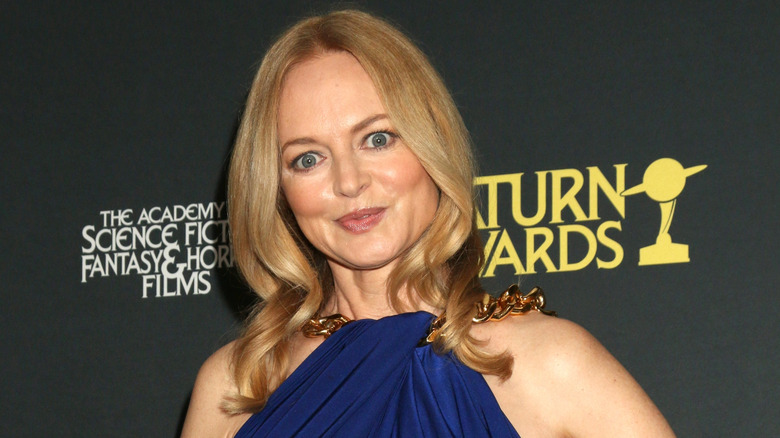 Heather Graham in blue dress with gold chain