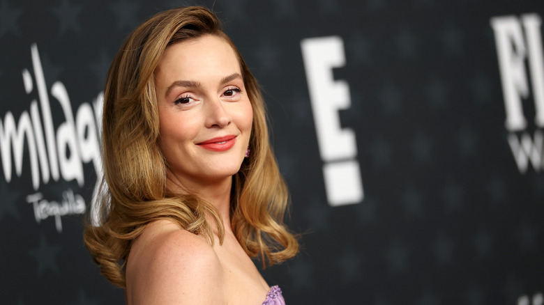 Leighton Meester looking over shoulder smiling in purple strapless dress and light brown hair
