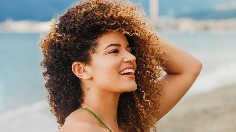 Woman showing off her colored hair on the beach