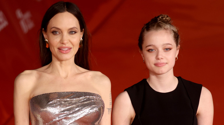 Angelina and Shiloh Jolie posing on red carpet
