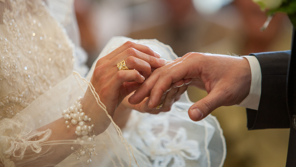 Couple exchanging rings during wedding