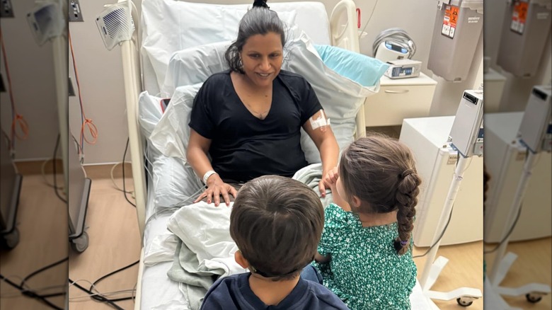 Mindy Kaling with two of her kids in a hospital bed