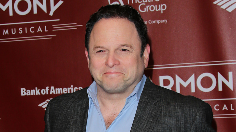 Closeup of Jason Alexander smiling on step-and-repeat